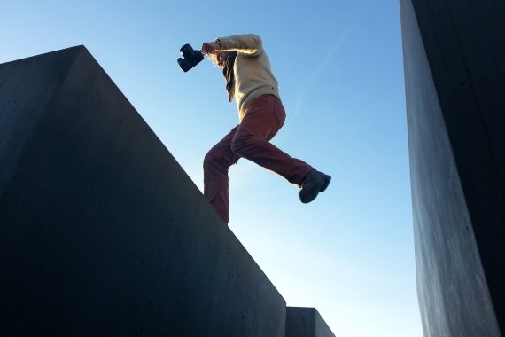 A man jumping between a gap on a roof